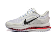 Side view of a white and gray Nike Pegasus Premium shoe with black Swoosh and red visible cushioning.