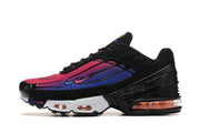 Side profile of a black sneaker with pink and purple gradient panels, a white midsole, and orange-tinted visible cushioning.