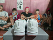 Rear view of the white Nike sneaker pair showing the padded heels and reflective-looking heel panels.