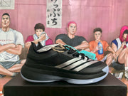 Side view of a black Adidas shoe with white stripes and a light-colored outsole.