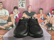 Front view of the black basketball sneakers showing the textured forefoot panels, black laces, and grey toe trim.