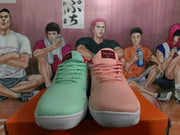 Front view of mint and pink Nike sneakers with matching laces and contrasting color details.