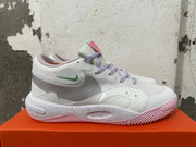 Side view of a white Nike basketball shoe with a mint-green Swoosh and speckled midsole
