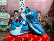 Angled view of blue and white Nike basketball sneakers with graphic upper panels, red details, and padded collars.