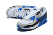 Angled top view of Nike Air Max 90 sneakers with white laces and blue accents.