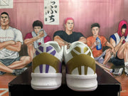 Rear view of white basketball shoes with purple and gold heel details and a speckled midsole