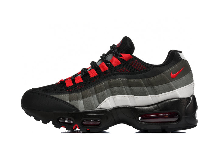 Side view of a black Nike Air Max 95 sneaker with grey and white layered panels, red accents and visible sole cushioning