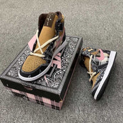 Three-quarter view of one sneaker on a decorated shoebox beside the matching second shoe.