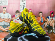 Yellow and black Nike basketball shoes displayed at an angle, showing the patterned upper and textured outsole.
