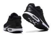 Rear and outsole views of black Nike Air Max sneakers.