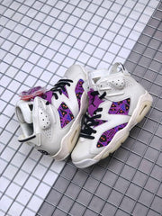 Pair of white and purple Jordan sneakers shown from above with extra lace colors.