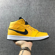 Side view of a yellow and black Jordan Air Jordan 1 Mid sneaker with a white midsole.
