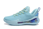 Side profile of a blue Curry sneaker showing the patterned upper and purple-and-gold heel cushioning detail.