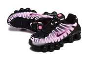 Pair of black and pink Nike Shox TL sneakers shown from angled front and side views.