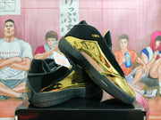 Angled view of the black and gold Jordan basketball shoes