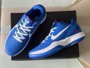 Top angled view showing the blue textured uppers, white laces, white Swooshes, and padded collars.