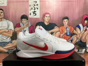 Side view of a white Nike basketball shoe with a red Swoosh and navy outsole detail.