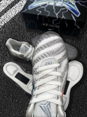 Top-down close-up of a grey and white basketball sneaker showing white laces, textured panels, and JA branding on the tongue.