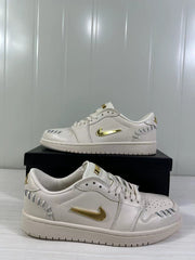 Side view of the white low-top sneaker with gold side branding.