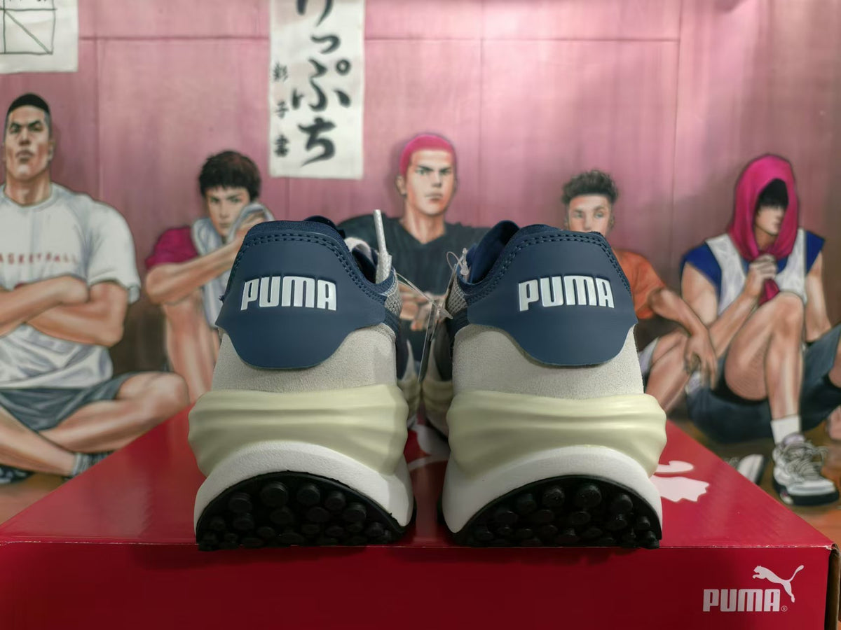 Rear view of white and navy PUMA Rider Elite sneakers