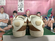 Rear view of brown PUMA low-top sneakers with cream heel panels and textured soles