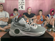 Side profile of a grey Nike KD basketball sneaker showing the patterned upper, layered Swoosh detail and sculpted sole.