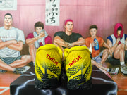 Rear view of yellow basketball shoes with black outsole and red heel lettering.