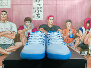 Front view of the pair showing the light blue uppers, blue lace details, perforated panels, and layered blue outsoles.
