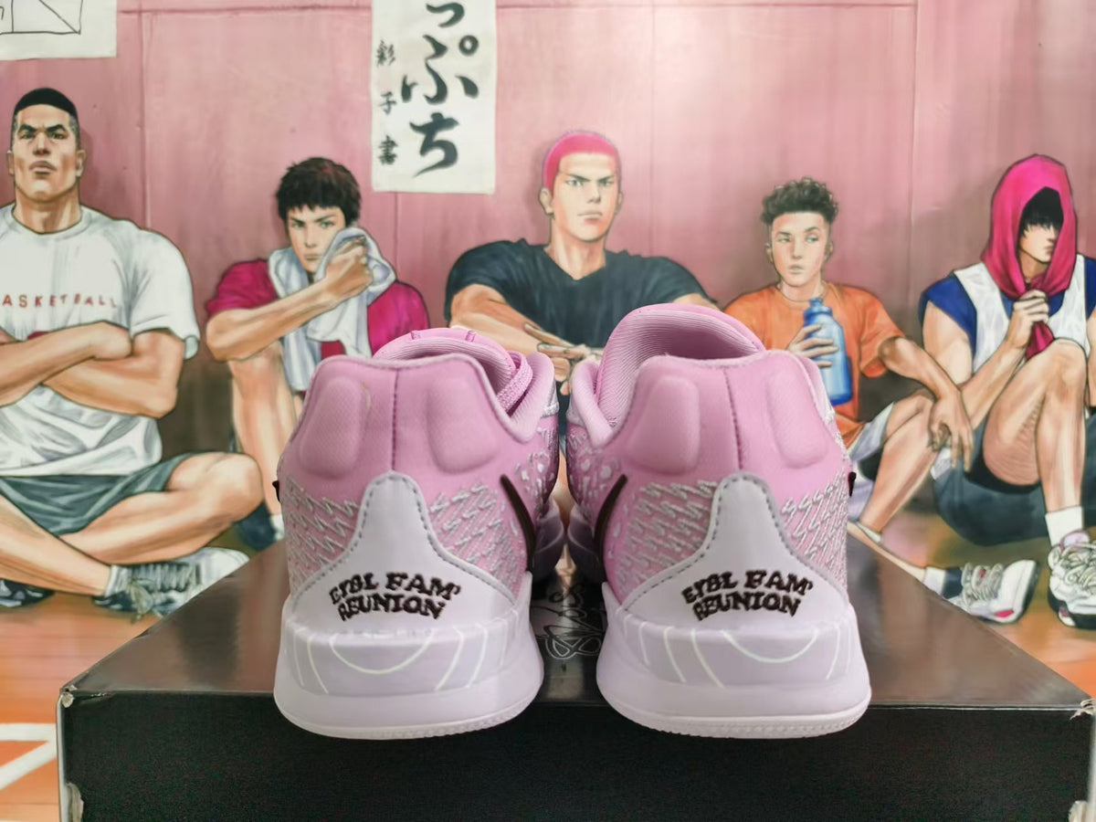 Rear view of pink and light gray basketball shoes with heel lettering