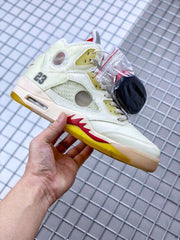 Detailed side profile showing the number 23, translucent mesh panels, red midsole accents, and yellow outsole.