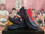 Angled view of two navy basketball sneakers with red laces, orange accent lines, heel details, and basketball-themed logos.