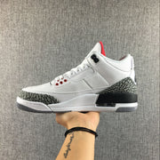 Side profile of the Jordan 3 sneaker with white upper, elephant-print overlays, and black heel detail