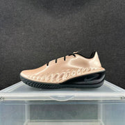 Side view showing the metallic pink upper, black outsole, and textured side detailing.