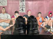 Rear view of black Nike basketball sneakers showing padded collars, glossy heel panels, and white heel markings.
