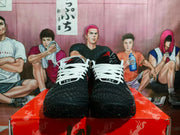 Front view showing black textured toe boxes, white laces, white collars, and red details.
