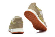 Rear view and orange-brown tread outsole of the sneakers