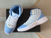 Top-down view of the pair showing white laces, light blue toe boxes, and patterned side panels.