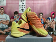 Pair of lime-yellow and orange Nike basketball sneakers with black Swooshes, shown at an angle.