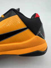 Close-up of the orange heel midsole, black collar, and heel details.
