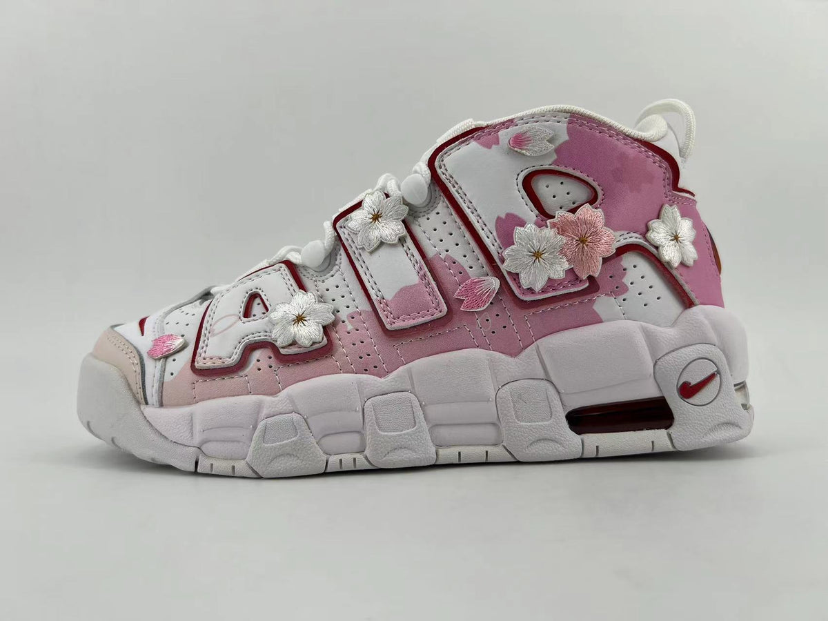 White and pink Nike Air More Uptempo sneaker with floral appliqués and a chunky sole