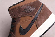 Close-up of the brown textured ankle panel, black Swoosh detail, stitching, and winged basketball emblem.