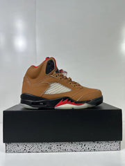 Side profile of a brown high-top sneaker with a contrasting perforated side panel and translucent outsole section.
