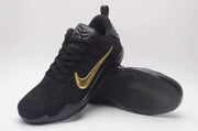 Black and gold Kobe 11 shoes shown from the front and outsole.