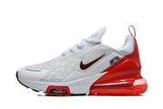 Side view of a white Nike Air Max 270 Premium sneaker with red accents and a visible heel unit.