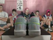 Rear view of the sneaker pair showing perforated heel panels, lime accents, pink trim, and Sabrina branding.