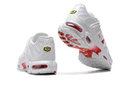 Rear and outsole views highlighting the heel badge and red-accented sole.