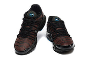 Front view of the pair of Nike Air Max Plus sneakers, showing the patterned uppers and black laces.