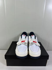 Front view showing the perforated toe boxes, white laces, forefoot straps and red branding details.