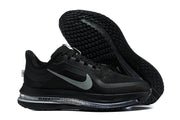 Black Nike running shoes shown from the side and outsole, with grey Swoosh detailing.