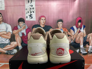 Rear view of off-white and brown Nike sneakers showing red heel graphics and translucent heel sections on a shoebox.